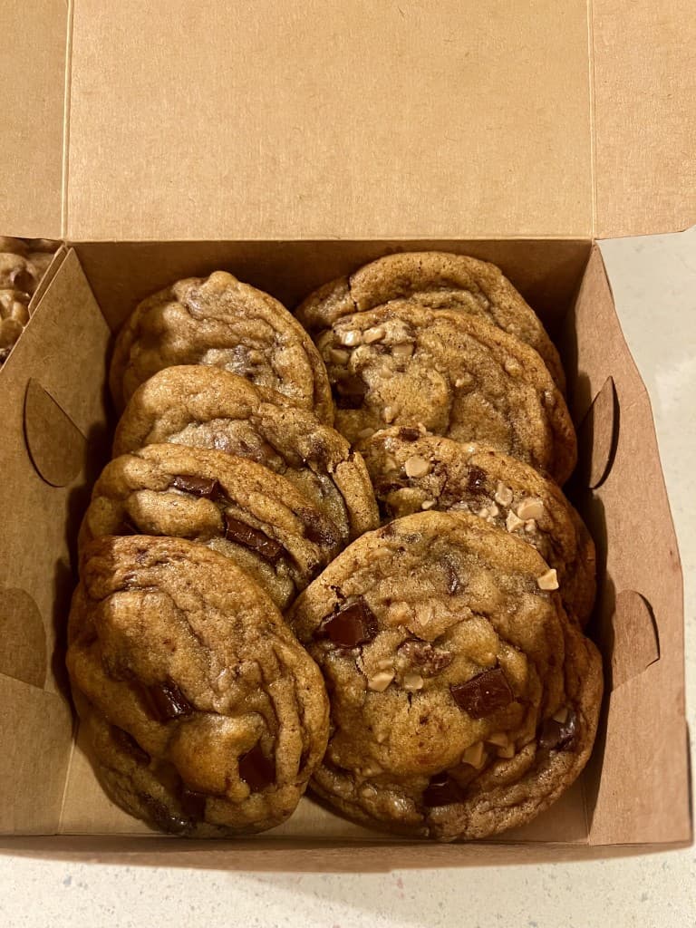 An open bakery box packed with brown butter cookies